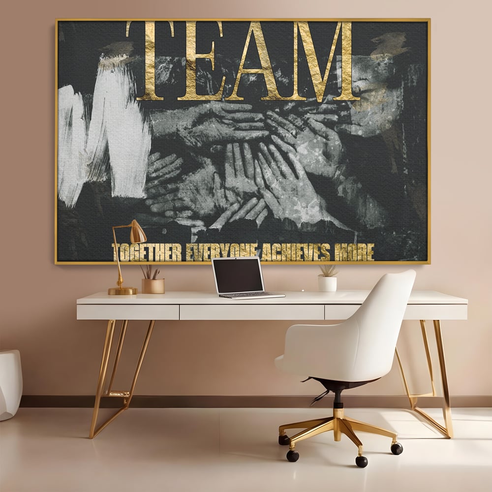 Tablou canvas cu tablou motivational cu maini si text, in rama de aluminiu auriu, pe perete intr-un birou